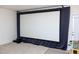 Finished basement with large projector screen, neutral carpet, and door to exterior at 4355 Pond Pine Trl, Morrisville, NC 27560