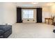 Finished basement features neutral carpet, and window with dark curtains at 4355 Pond Pine Trl, Morrisville, NC 27560