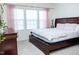 Comfortable bedroom with a large bed, dresser, and natural light from the large windows at 4355 Pond Pine Trl, Morrisville, NC 27560
