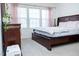 Cozy bedroom featuring a queen bed, dresser, and an abundance of natural light from the windows at 4355 Pond Pine Trl, Morrisville, NC 27560