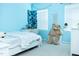 Blue bedroom with a white bed, a desk and macrame wall decoration at 4355 Pond Pine Trl, Morrisville, NC 27560