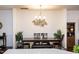 Elegant dining room with wooden table and bench seating, featuring a stylish chandelier at 4355 Pond Pine Trl, Morrisville, NC 27560