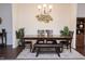 Comfortable dining area with a long wooden table, accent rug, and decorative wall art at 4355 Pond Pine Trl, Morrisville, NC 27560