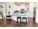 Bright kitchen features white cabinets, stainless steel appliances, and a quartz breakfast bar at 4355 Pond Pine Trl, Morrisville, NC 27560