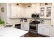 Modern kitchen features stainless steel appliances, light countertops, and a tile backsplash at 4355 Pond Pine Trl, Morrisville, NC 27560