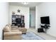 Comfortable living room featuring a cozy couch, entertainment center, and a vibrant area rug at 4355 Pond Pine Trl, Morrisville, NC 27560