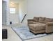 Cozy living room with plush sofa, area rug, and natural light creating a welcoming and comfortable space at 4355 Pond Pine Trl, Morrisville, NC 27560