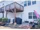 Back patio with overhead deck, grill, and potential for landscaping at 4355 Pond Pine Trl, Morrisville, NC 27560