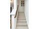 Carpeted staircase with painted risers and wooden banister at 4355 Pond Pine Trl, Morrisville, NC 27560