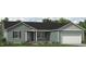 Charming single-story home with a well-maintained lawn, attached garage, and inviting front porch at 4451 Poppy Mallow Ln, Oxford, NC 27565