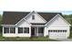 Attractive home with a two-car garage, gabled roof and a cozy front porch, complemented by meticulously maintained landscaping at 4459 Poppy Mallow Ln, Oxford, NC 27565