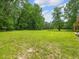 Wide open space with mature trees and a stone fire pit at 4508 Old Us 421 N N, Siler City, NC 27344