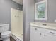 Bathroom with white shower, toilet, vanity and gray colored walls at 4508 Old Us 421 N N, Siler City, NC 27344