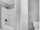 Bathroom with white bathtub, tiled shower, and built-in storage cabinet at 4508 Old Us 421 N N, Siler City, NC 27344