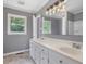 Bathroom with double sink vanity, large mirror, tiled floor, and window at 4508 Old Us 421 N N, Siler City, NC 27344