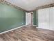Bedroom with hardwood floors, neutral walls, closet, and open door to hall at 4508 Old Us 421 N N, Siler City, NC 27344