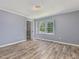 This bedroom features gray walls, wood-look flooring, and a window with natural light at 4508 Old Us 421 N N, Siler City, NC 27344