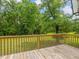 Wood deck with wooden railing overlooking yard with mature trees at 4508 Old Us 421 N N, Siler City, NC 27344