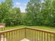 Wood deck with wooden railing overlooking backyard with mature trees at 4508 Old Us 421 N N, Siler City, NC 27344