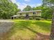 Traditional two-story home with an attached two-car garage and a well-maintained lawn with mature trees at 4508 Old Us 421 N N, Siler City, NC 27344