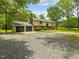 Traditional two-story home with an attached two-car garage and a well-maintained lawn with mature trees at 4508 Old Us 421 N N, Siler City, NC 27344
