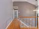 Hallway with wood floors, white trim, and view of stairs and open doorway at 4508 Old Us 421 N N, Siler City, NC 27344