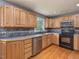 Modern kitchen featuring wood cabinets, stainless steel appliances, and hardwood flooring at 4508 Old Us 421 N N, Siler City, NC 27344