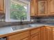 Kitchen sink area with stainless steel sink and wood cabinets at 4508 Old Us 421 N N, Siler City, NC 27344