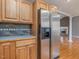 Kitchen with stainless steel refrigerator, oak cabinets and decorative tile backsplash at 4508 Old Us 421 N N, Siler City, NC 27344