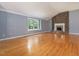 Spacious living room featuring hardwood floors, a brick fireplace, and ample natural light at 4508 Old Us 421 N N, Siler City, NC 27344