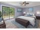 Staged main bedroom with neutral walls, ceiling fan, and sliding glass door to deck at 4508 Old Us 421 N N, Siler City, NC 27344