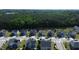 An aerial shot of houses on a street surrounded by trees, featuring driveways and crosswalk at 4907 Sleepy Falls, Knightdale, NC 27545
