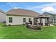 Grassy backyard featuring a gazebo, outdoor seating, a built-in grill, and a stone firepit at 4907 Sleepy Falls Run, Knightdale, NC 27545