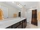 Bathroom with large mirror, bright lighting, and white shower at 4907 Sleepy Falls Run, Knightdale, NC 27545