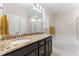 Well-appointed bathroom features double sinks, granite countertops, a soaking tub, and a walk-in shower at 4907 Sleepy Falls Run, Knightdale, NC 27545