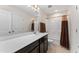 Bathroom with double-door entry, brown shower curtain, and quartz countertop at 4907 Sleepy Falls Run, Knightdale, NC 27545