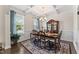 Bright dining room boasts a beautiful china cabinet, coffered ceiling, and large windows at 4907 Sleepy Falls Run, Knightdale, NC 27545