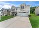 Attractive two-story home featuring a large driveway, attached two-car garage, and manicured front lawn at 4907 Sleepy Falls Run, Knightdale, NC 27545