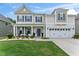 Beautiful two-story home with a welcoming front porch, manicured lawn, and convenient two-car attached garage at 4907 Sleepy Falls Run, Knightdale, NC 27545