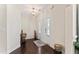Warm and welcoming foyer featuring gleaming hardwood floors, a white front door with sidelights, and neutral walls at 4907 Sleepy Falls Run, Knightdale, NC 27545