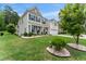 Well-maintained two-story home, with a lush lawn, trimmed shrubs, and a cozy front porch sitting area at 4907 Sleepy Falls Run, Knightdale, NC 27545