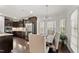 Kitchen with stainless steel appliances and dark cabinets adjacent to dining area at 4907 Sleepy Falls Run, Knightdale, NC 27545