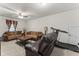 Cozy living room with plush sofas, a ceiling fan, and a treadmill at 4907 Sleepy Falls Run, Knightdale, NC 27545