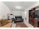 Comfortable living room with seating, a TV, and a brown cabinet at 4907 Sleepy Falls Run, Knightdale, NC 27545