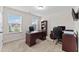 Bright office space with built-in shelves, large desk, and natural light from two large windows at 4907 Sleepy Falls Run, Knightdale, NC 27545
