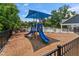 Playground with a slide and shade cover, set within a fenced recreational area, next to a pool at 4907 Sleepy Falls Run, Knightdale, NC 27545