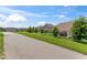 Scenic street showcasing well-kept lawns and elegant homes in a charming neighborhood at 4907 Sleepy Falls Run, Knightdale, NC 27545