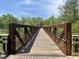 Image shows a walking bridge over a wooded area at 5208 Ranger Grove Way, Raleigh, NC 27604