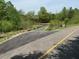 Image shows a paved walking trail with a bridge in the background at 5208 Ranger Grove Way, Raleigh, NC 27604