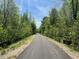 Image shows a paved walking trail surrounded by trees at 5208 Ranger Grove Way, Raleigh, NC 27604